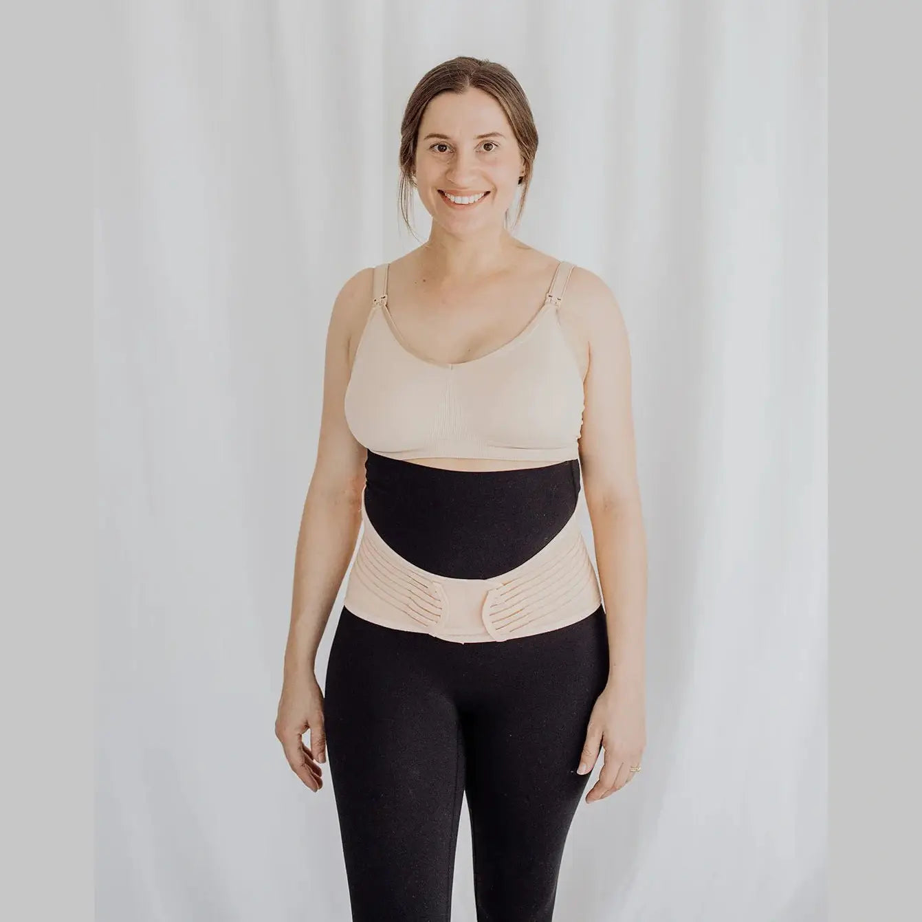 Women wearing postpartum belly band around waist