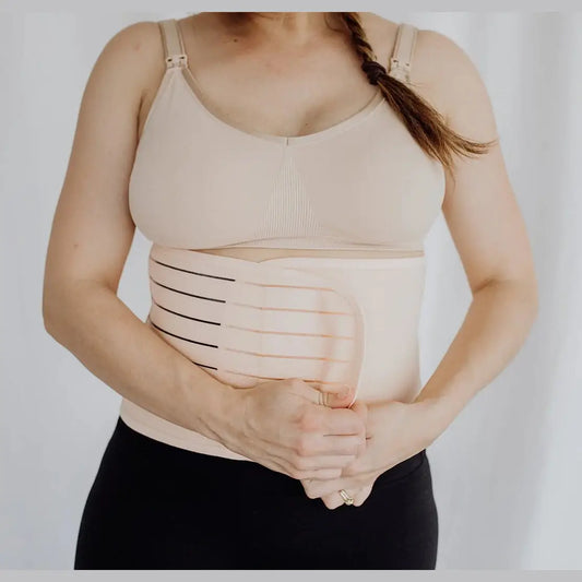 Women wearing postpartum belly band around waist