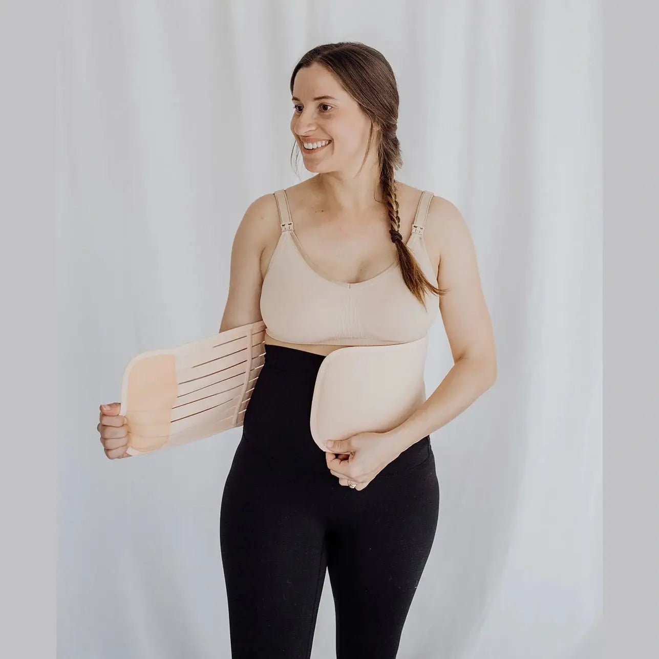 Women wearing postpartum belly band around waist